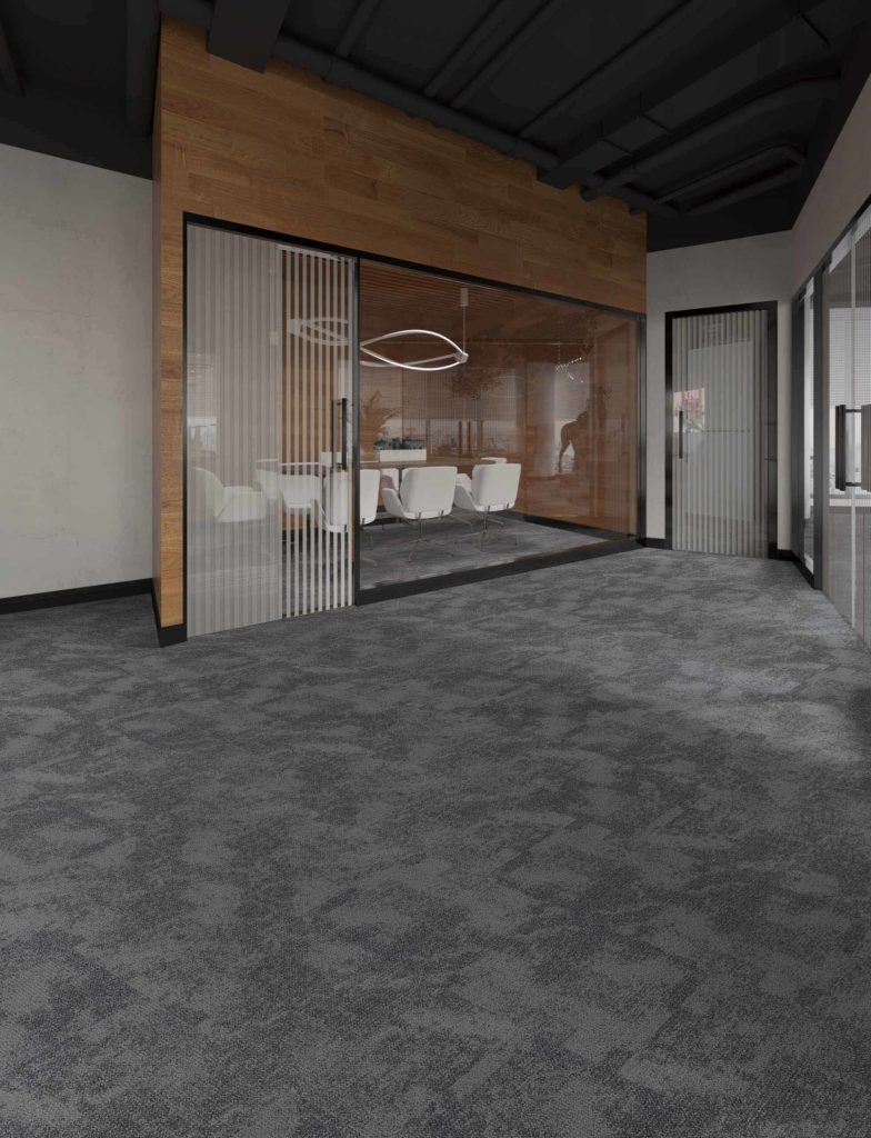 Photo of a spacious office area with gray carpet tile flooring. The tiles' uniform color and texture provide a professional and polished look.