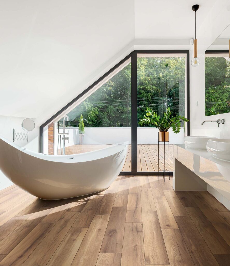 Beautiful waterproof flooring in a bathroom with a large tub and windows. 